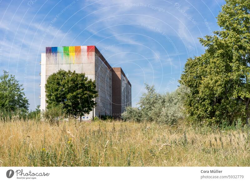 Empty apartment block in East Germany with graffiti painting in rainbow colors block of flats Prefab construction disk Uninhabited Stendal Eastern Germany