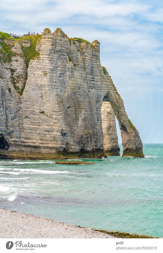 Around Etretat in France normandy france seine-maritime sea ocean coast cliff rock formation beach chalk cliff rock face summer sunny natural arch overgrown