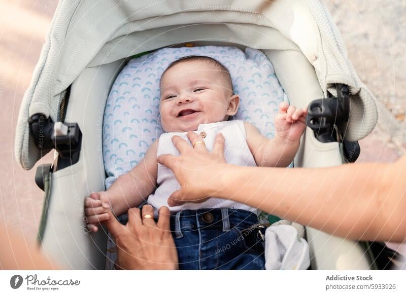 Generated image baby stroller lesbian couple family joy bonding smile hands infant love happiness child parenting mothers outdoors sunshine care comfort casual