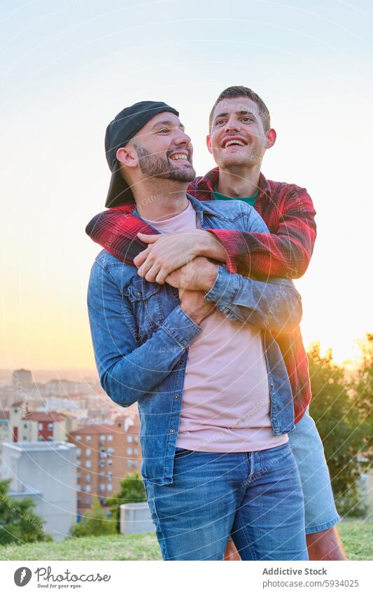 Gay couple enjoying a romantic moment at sunset gay couple love cityscape embrace smile content tranquil skyline outdoors scenic together happiness partner