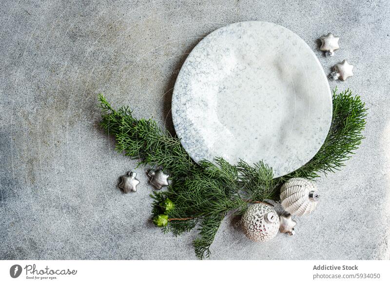 Christmas decorations and pine branches on concrete christmas ornament background texture holiday minimalist festive composition top view textured flat lay