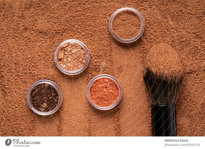 Top view of assorted make-up brushes and cosmetics powder top view beauty texture brown background container eyeshadow mineral makeup tool pigment blush fashion