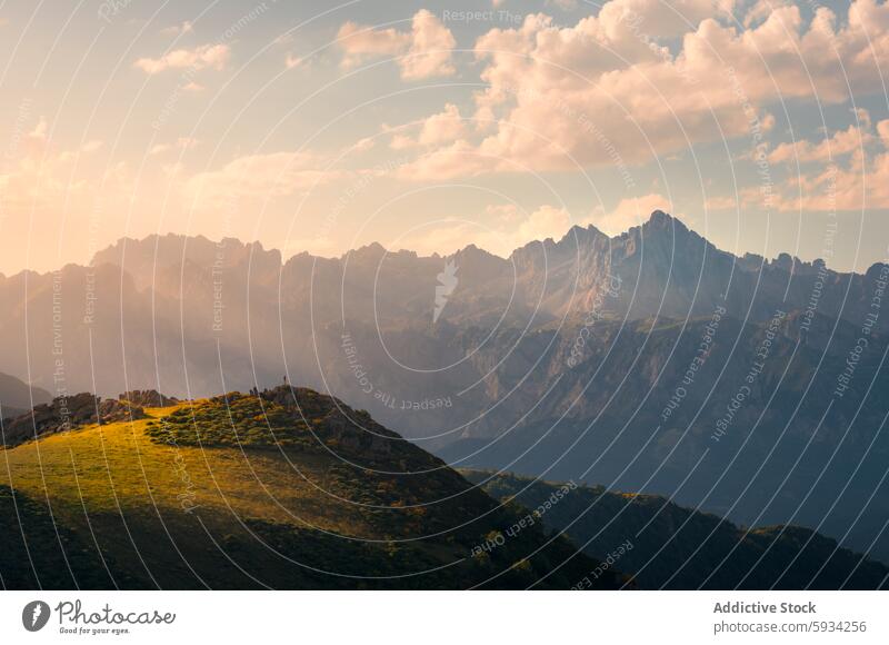 Back view of an unrecognizable person exploring Picos de Europa anonymous back view picos de europa sunset adventure nature hilltop golden exploration travel