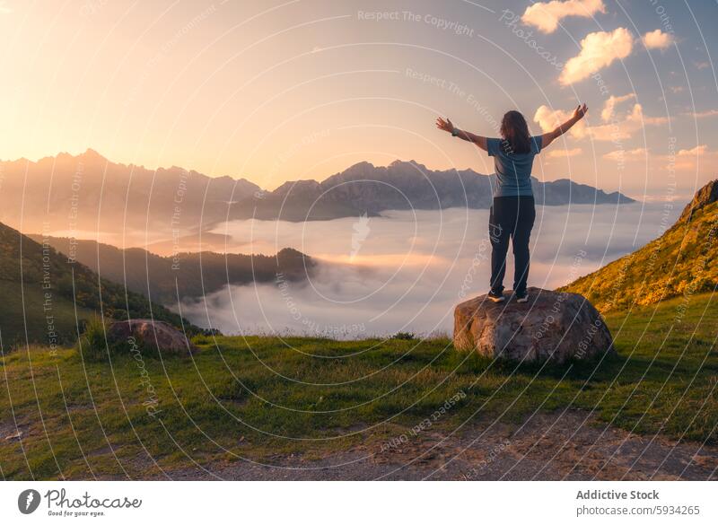 Back view of unrecognizable person enjoying Picos de Europa sunrise mountain clouds valley woman back view freedom nature scenic picos de europa rocky peak