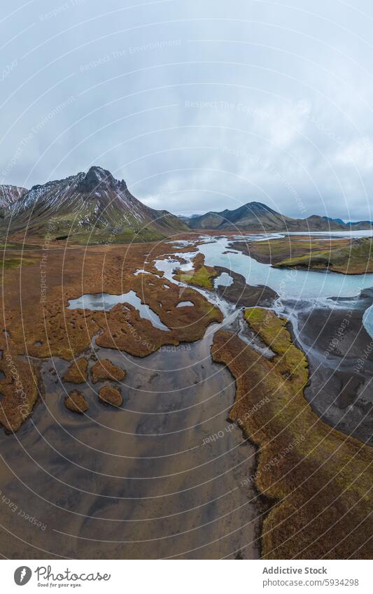 Serene Icelandic highland landscape with mountain river iceland terrain moss sky cloudy rugged peak tranquil natural scene scenery serene outdoor travel