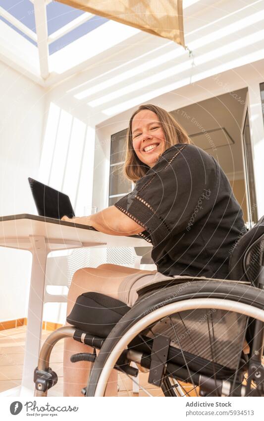 Businesswoman in wheelchair working with laptop at home businesswoman productivity determination accessibility independent empowering disability professional