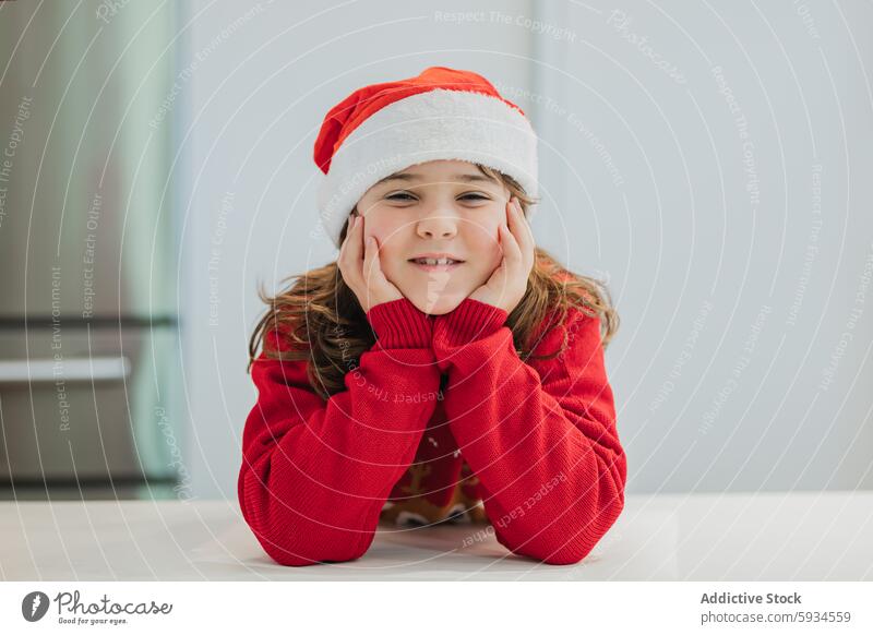 Young girls in festive attire cooking for Christmas christmas twin child kitchen baking cookie santa hat holiday sister family celebration december winter