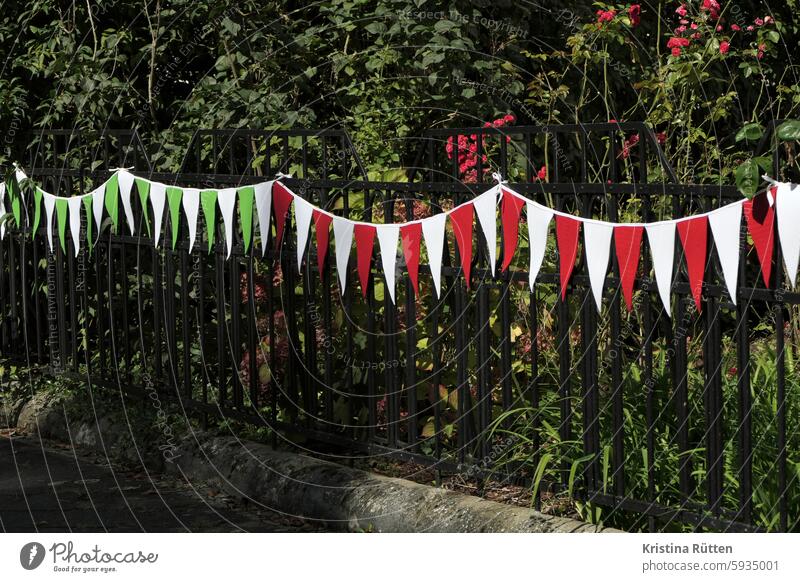 red white and green white pennants on the garden fence pennant chain Paper chain flag Garden fence Fence Red White Green flowers Front garden Decoration