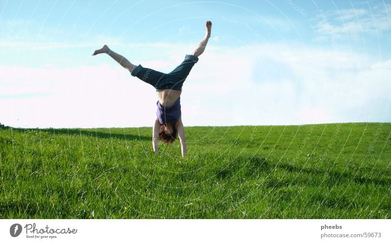 upside down Grass Meadow Gymnastics Woman Go crazy Green Clouds Lawn Stomach Shadow Blue Nature Freedom