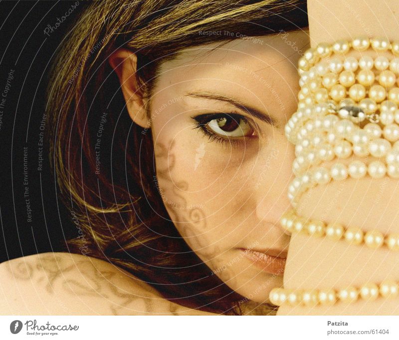 killing glance Woman Portrait photograph Feminine Hand Jewellery Pearl necklace Strand of hair Black Brown Face Eyes Looking tattoo Shadow Human being