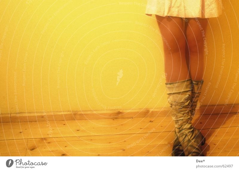 dirty Woman Yellow Stand Boots Wall (building) Wooden floor Thigh Calf Legs Human being Wait Skin Lean Shadow