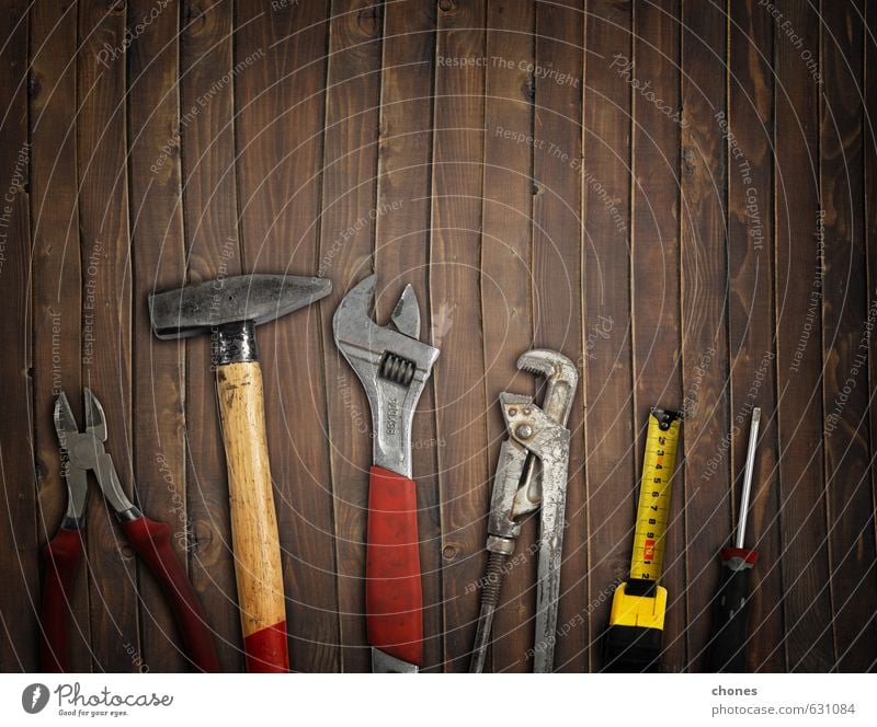 Hammer Pliers And Soldering Iron On Wooden Background Stock Photo