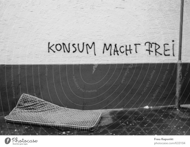 Consumption makes you free. Wall (barrier) Wall (building) Lamp post Sidewalk Mattress Graffiti Wet Fear of the future Inequity Deserted Poverty Freedom Society