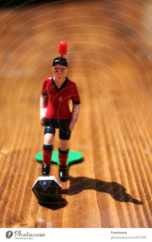 The ball has corners... Red Black Brown Wood White Things Obscure Shadow Sports Table soccer Piece 1 Bump Front view Shallow depth of field Wood grain
