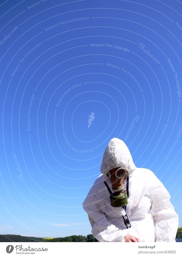 Mans in protective hazmat suit, blue sky Stock Photo by