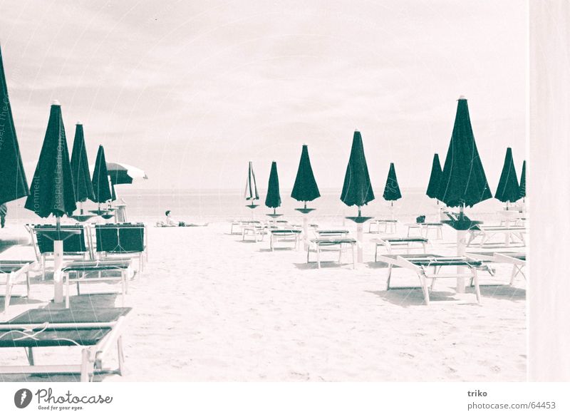 umbrellas Beach Sunshade Closed Man Sunbathing Ocean Vacation & Travel Italy Serene Relaxation Sand Loneliness black/white film c41 Lie