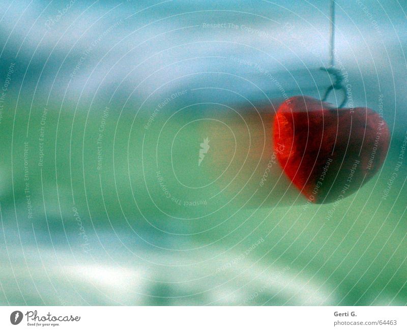 red heart with motion blur at the right edge of the picture in front of a green-blue background Red Green Speed Motion blur Swing String Love Peace Heart Blue