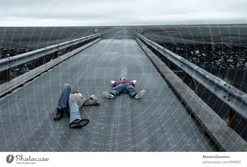 midnight nap Man Human being Sleep Relaxation Horizon Lava Gray Iceland Extreme Dark Cozy Comfortless Crash barrier Clouds Sky Bad weather Freedom Exterior shot