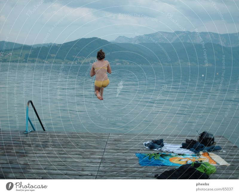 the peace before the ... Lake Cold Lake Attersee Woman Girl Bikini Jump Gray Heap Clothing Footbridge Panorama (View) Towel Backpack Yellow Evening Blue Stairs