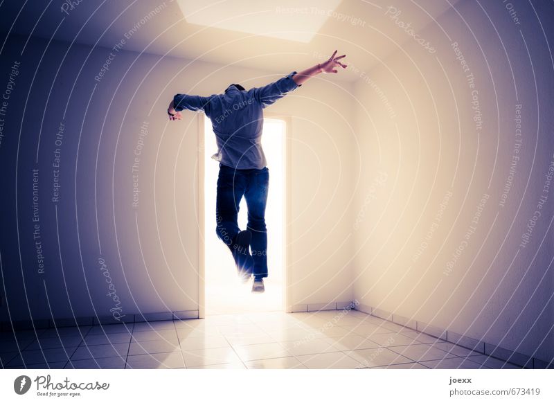 Man jumps through door into light Adults 1 Human being Wall (building) Jump Bright Blue Brown Black White Force Hope Dream Movement End Resolve Target Hover