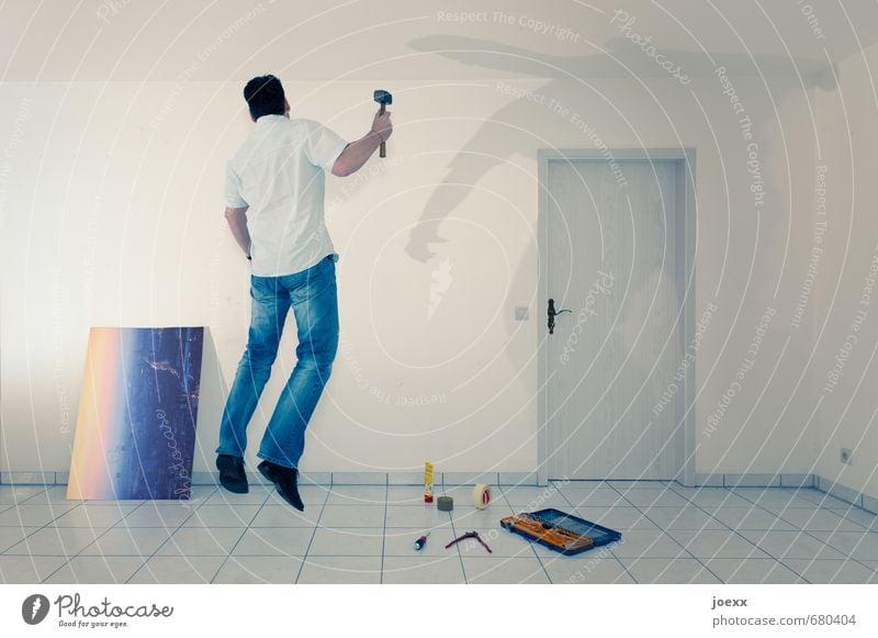 Man attaching a hanger for picture Redecorate Arrange Hammer Masculine Adults 1 Human being Wall (barrier) Wall (building) door Work and employment