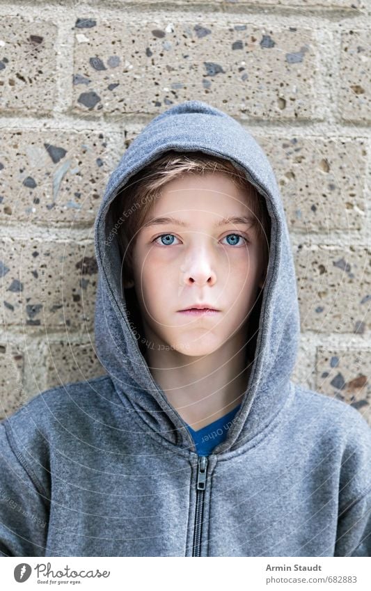 portrait of a teenager boy with hoodie in front of a wall Lifestyle Style Beautiful Human being Masculine Youth (Young adults) 1 8 - 13 years Child Infancy