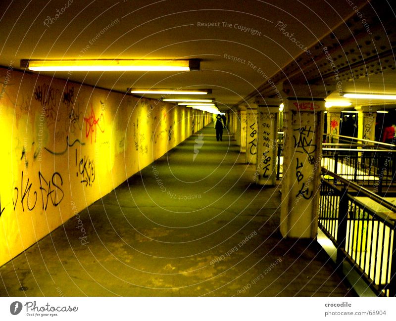 way to the vanishing point Yellow Underground Lamp Oppressive graffiti Berlin Column Lanes & trails Human being Corridor