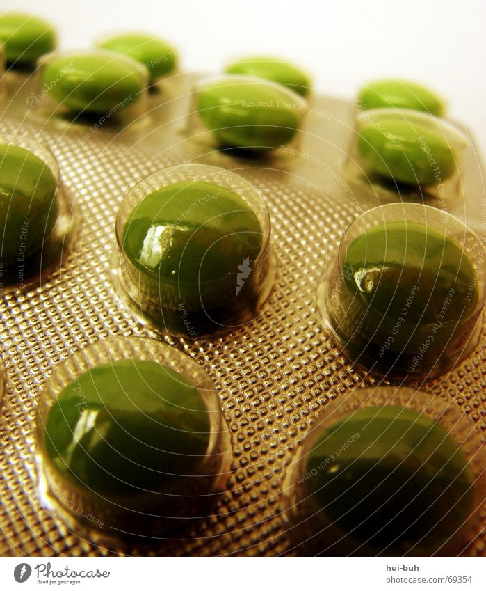 pills in the box Medication Pill Packaging Green Light Reflection Doping olive green Row Olive Detail Section of image Partially visible Dragee Packaged