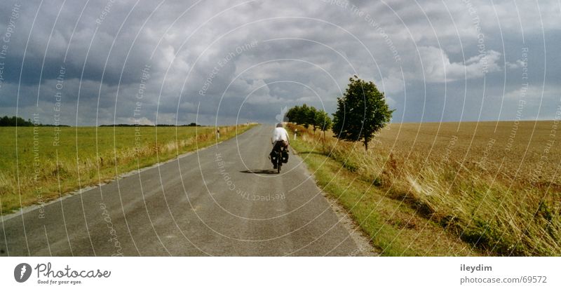 biker Field Clouds Bicycle Vacation & Travel Driving In transit Mobility Kick about Lanes & trails Sky Trip Mountain Nature