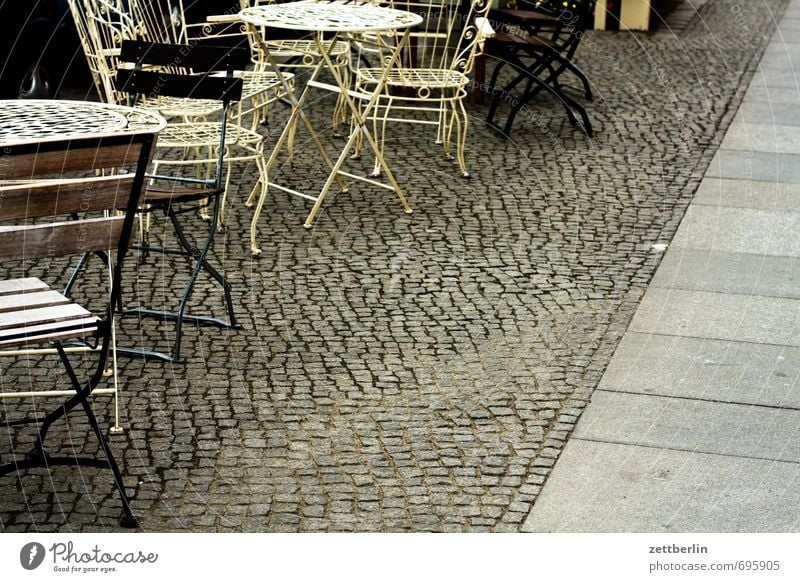 season start Chair Table Furniture Café Coffee To have a coffee Seating Sit Sidewalk café Footpath Paving stone Cobblestones Pavement Deserted Copy Space
