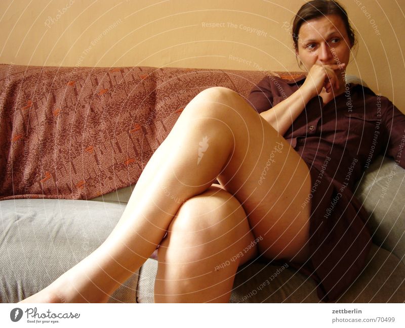 Incorrect focal length Woman Portrait photograph Sofa Skeptical Gray Brown Yellow Legs Sit peek