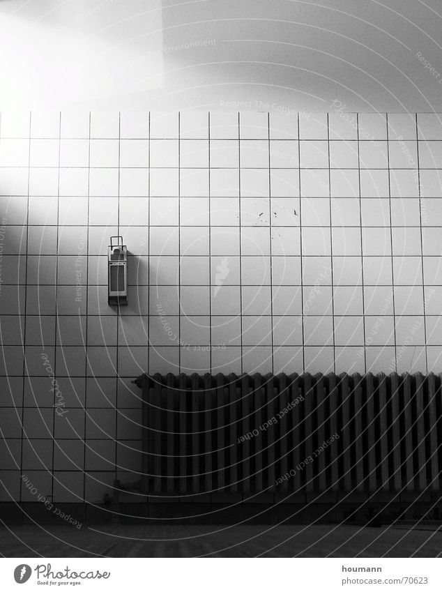 Light in cold room bathroom white building radiator dark hot soap dispenser shadow loneliness emptyness sad worn bw high contrast object Wall (barrier)