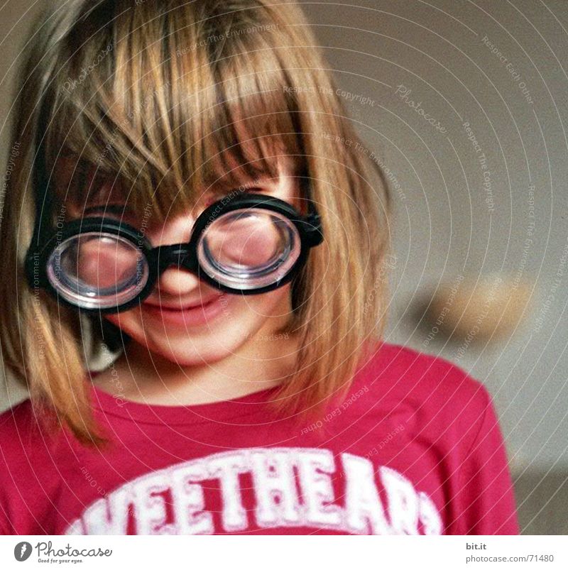 Little girl with pony wearing glasses / horn-rimmed glasses with high dioptres 3 - 8 years portrait Face of a child Childs upper body Blonde Bangs Eyeglasses
