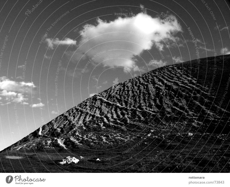 Heaven and earth Clouds Gray Air Meadow Alpine pasture Dolomites South Tyrol Italy Sky Earth Landscape Black & white photo Curve Nature Stone ladinia