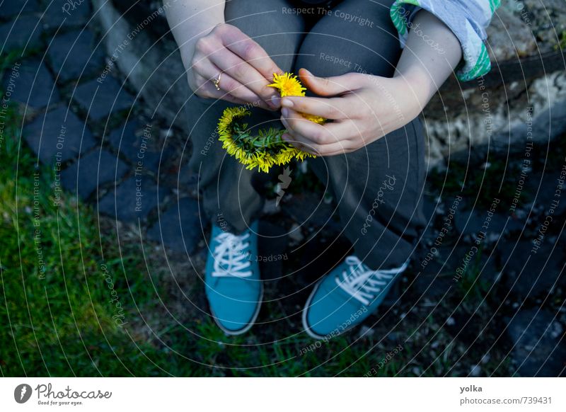 Young woman holds circlet of dandelion flowers in her hand Human being Feminine Youth (Young adults) Hand Fingers 1 18 - 30 years Adults Spring Summer