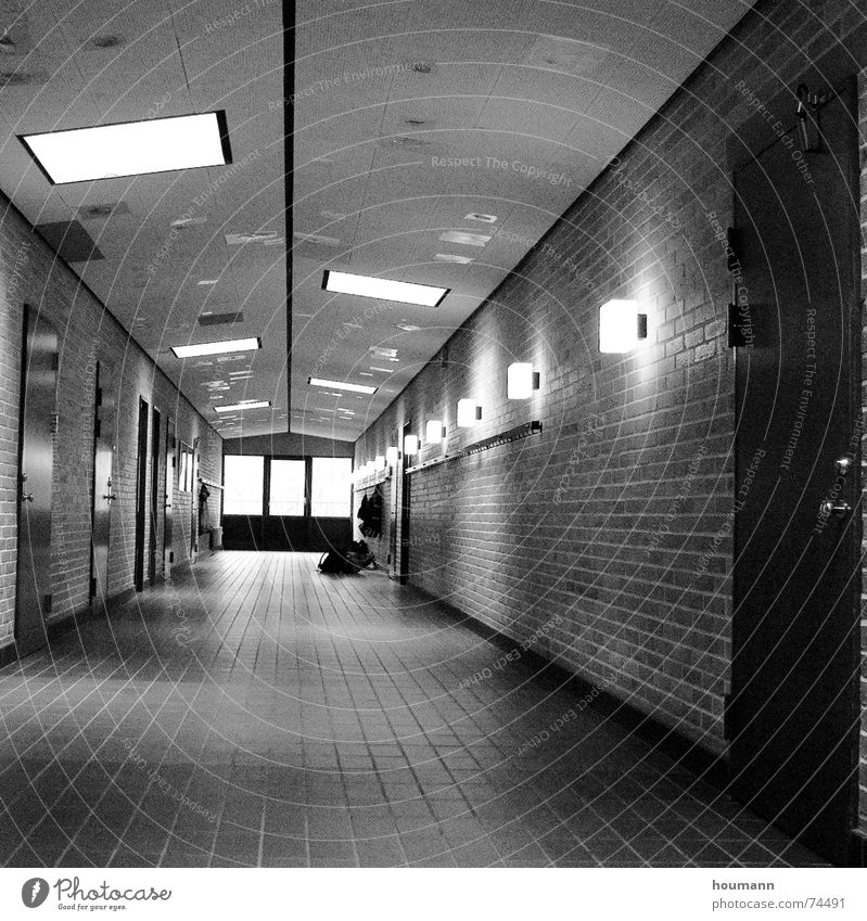 Neverending story Light Loneliness Wall (building) Floor covering Brick Lamp Dance floor long corridor Shadow bw Door Blanket Line Tile Black & white photo