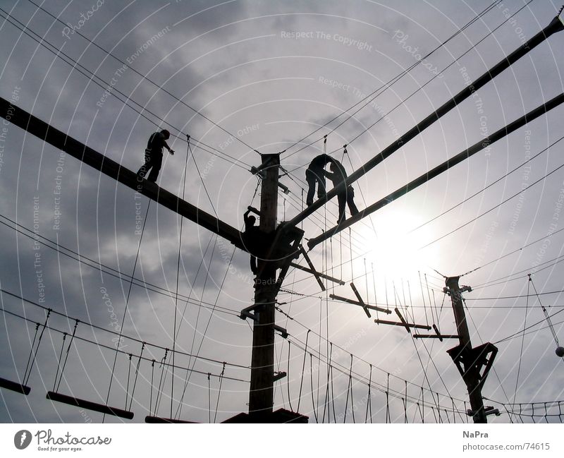 Hanging on the ropes Wire Light Mountaineer Action Safety Trust Power Climbing Sports Sportsperson Rope Sky Sun Electricity Joy fun Brave Fear