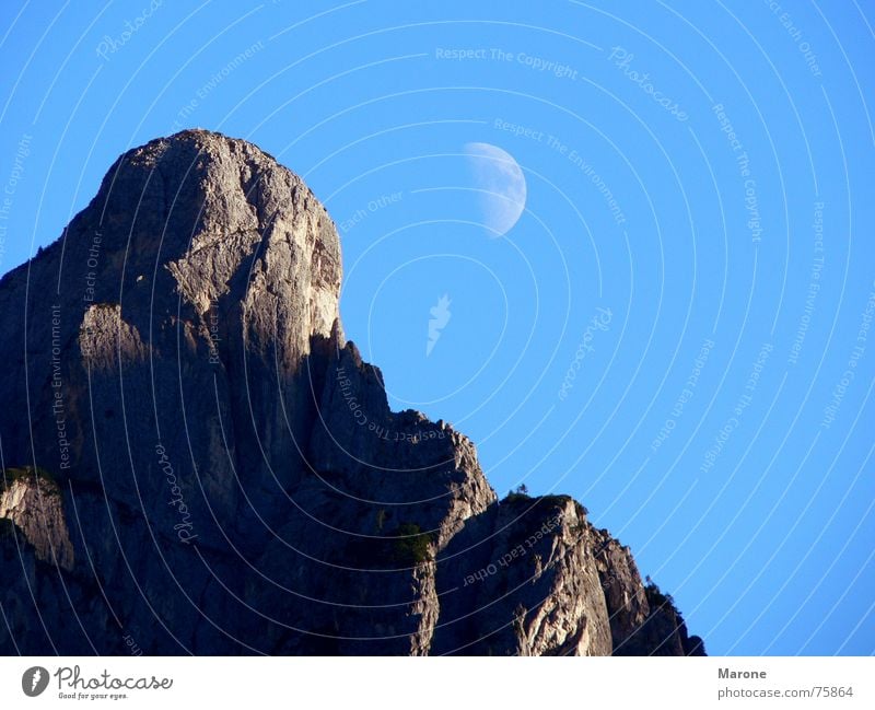 Moonrise on the mountain Half moon Crescent moon Mountain ridge Weightlessness Dolomites Mountain range Celestial bodies and the universe Above ridges Rock Sky