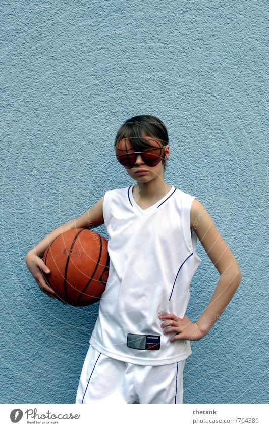 Girl in basketball jersey with basketball under arm and eyes in basketball shape Child 1 Human being 0 - 12 months Baby Wall (barrier) Wall (building) Jersey