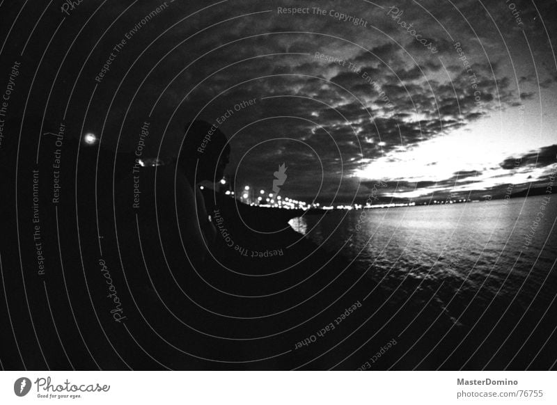 There will be night in Reykjavík Ocean Town Building Iceland Clouds Man Cap Crouch Looking Analog Sky Light Bay Black & white photo Human being