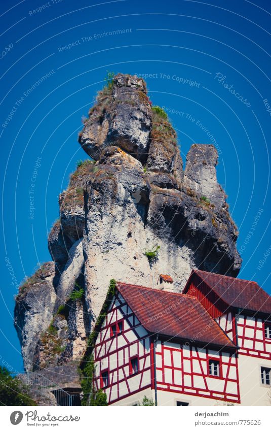 Blue sky, half-timbered houses on the mountain, striking rock towers in Tüchersfeld / Püttlachtal - Franconia / Bavaria Calm Leisure and hobbies