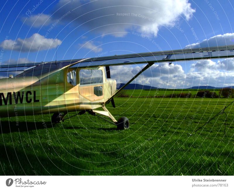 Microlight aircraft on meadow before take-off Leisure and hobbies Aviation Sky Clouds spring Beautiful weather Wind Grass Meadow Field Means of transport