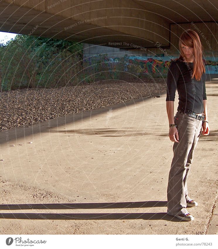 = Human being Woman Young woman Stand Thin Chucks Long-haired Red-haired Dark Shadow Stone Concrete Bushes Appearance Physics Brown Autumn Evening sun Bridge