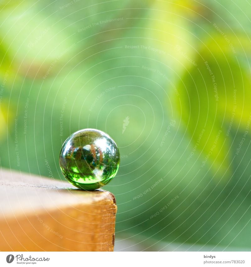critical moment Table edge Marble Glass ball Glittering Esthetic Friendliness Positive Round Green Calm Unwavering Contentment Pure Risk Children's game Sphere