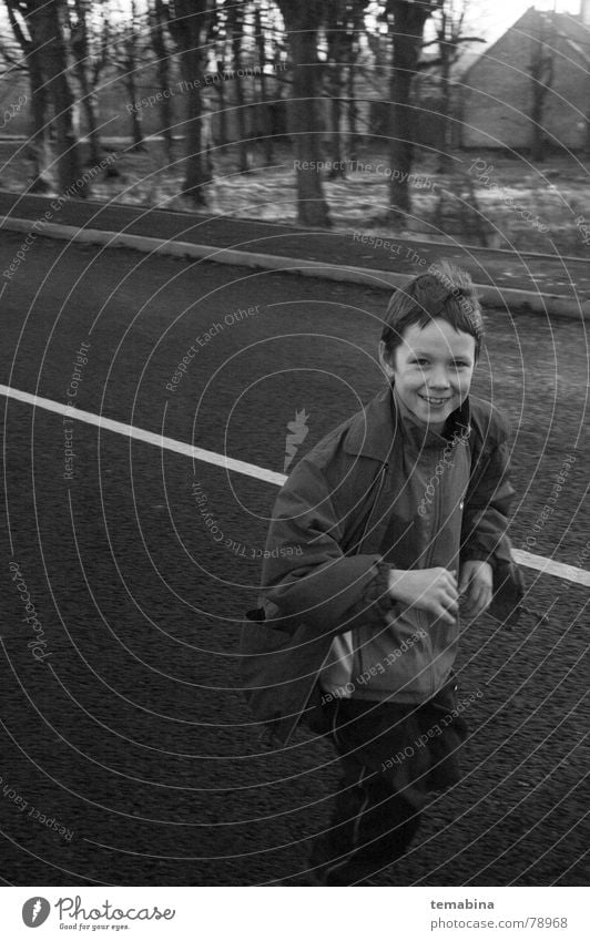 boy running Monochrome Riga Grinning Joy suburban smiling white street Black & white photo