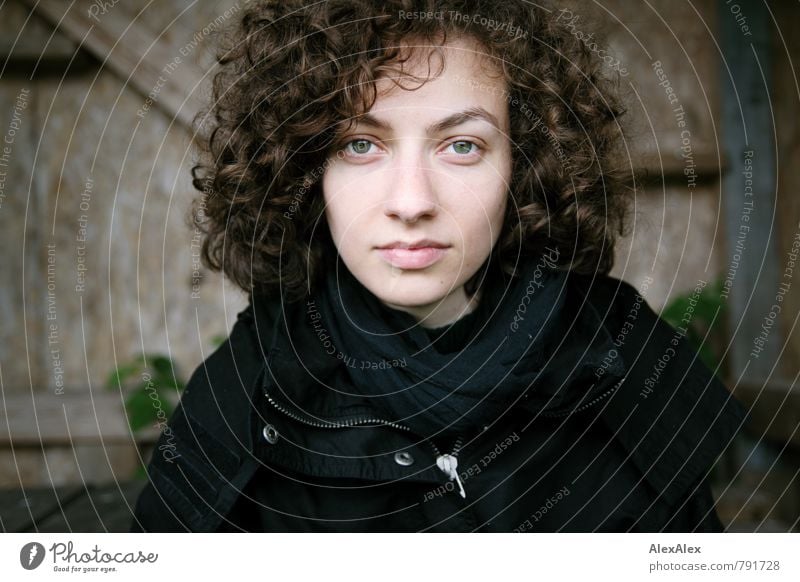 young woman with brunette curls looks at camera Trip Young woman Youth (Young adults) Head Hair and hairstyles 18 - 30 years Adults Plant Exterior shot