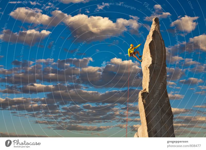 Climber tiptoes on the edge. Adventure Climbing Mountaineering Success Rope 1 Human being 30 - 45 years Adults Clouds Peak Helmet Self-confident Brave
