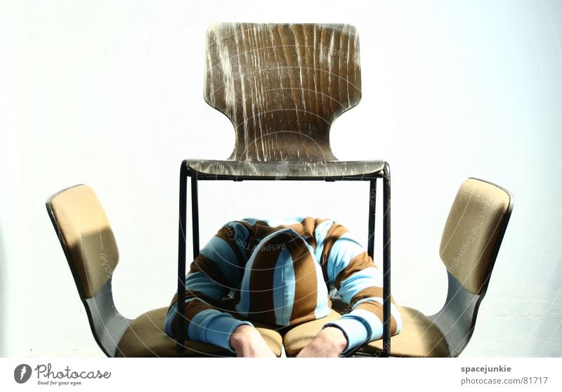 Between all chairs Hooded sweater Under Chair Hand Hiding place Office work Man Sweater Whimsical Proverb Strange Figure of speech Backrest Write Seating