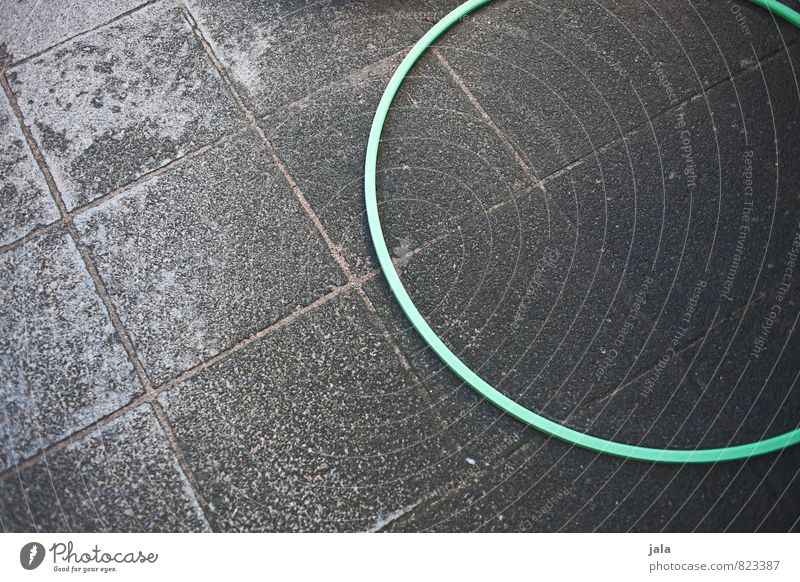 hoop Hula hoop Places Paving stone Lie Good Gloomy Leisure and hobbies Colour photo Exterior shot Copy Space left Copy Space right Neutral Background Day