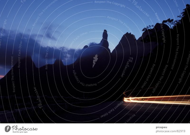 The Finger of God Tracer path Black Twilight Virgin forest Clouds Silhouette Mountain range Evening Contour Floodlight Light Long exposure Blue Curve Dusk Flare